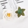 Detail shot of artificial white rose flower heads, showing front petal layers and green calyx back. - White