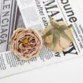 Close-up detail of artificial burnt-edge rose flower heads showcasing vintage petal layers. - Style 16