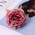 Macro detail shot of artificial pink rose flower head silk material for wedding decor prop. - Pink