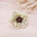 Close-up detail of vintage artificial camellia silk flower with dark stamen on pink tulle. - Style 8