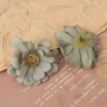 Artificial daisy flower heads detail shot, multi-layered fabric craft flower for DIY decor. - Dark Green