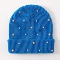 Detailed view of women's blue knit beanie featuring delicate pearls and sparkling rhinestones. - One Size / Blue