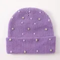 Detail view of women's purple knitted beanie featuring pearl and rhinestone embellishments. - One Size / Purple