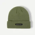 Detail shot of the textured green knit beanie showing the front woven label and fine stitching. - One Size / Green