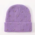 Nahaufnahme der funkelnden strassbesetzten, violetten Winter Strick Beanie Mütze. - Lila