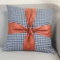 Detail view of the houndstooth cushion featuring a chic brown leather bow splice design. - 45*45 cm Pillowcase (Insert Not Included) / Houndstooth