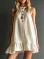 Detail shot of sleeveless linen-blend dress featuring high collar, buttons, and ruffle hem. - S / Light Yellow