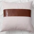 Detailed close-up of the striped pillow featuring a stylish brown leather center patch design. - 45*45 cm Pillowcase (Insert Not Included) / Pink