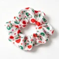 Christmas printed satin hair scrunchie, white fabric hair tie with red and green holiday motifs. - White