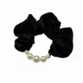 Close-up detail of the elegant black fabric hair scrunchie with faux pearl bead decoration. - Black