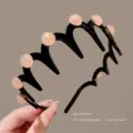 Black multi-tooth wave headband with pink pearl details, stylish anti-slip hair accessory. - Orange