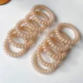 Close-up detail shot of matte nude telephone cord hair ties, highly elastic and minimalist. - 1 Piece Pack / Beige