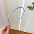 Blue wave headband with teeth, glossy finish hair accessory, sweet style detail view. - Blue
