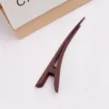 Detail view of large brown matte duckbill hair clip, elegant hair accessory for daily styling. - Red Brown