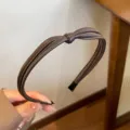 Close-up detail of brown PU leather braided headband, stylish hair accessory for women. - Coffee