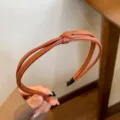Brown PU leather braided knotted headband for women daily hair styling and elegant looks. - Caramel color