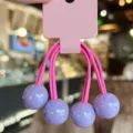 Cute candy color hair ties with glossy purple balls on pink display card for girls sweet styling. - Purple