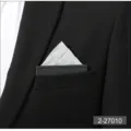 Close-up view of a sleek silver pocket square neatly inserted in a black suit pocket. - Gray