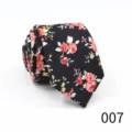 Detailed shot of a stylish black floral necktie, pointed design for business casual wear. - Color 007