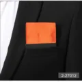 Men's solid orange pre-folded pocket square suit handkerchief chest accessory detail view. - Orange