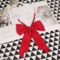 Detail shot of a solid red big bow JK uniform tie with elastic neck strap for cute style. - 014