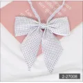 Close-up detail of a white JK uniform bow tie featuring classic black polka dot pattern. - 008 White with Black Dots