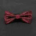 Detailed view of a classic red and black striped bow tie with white dots for men's formal suit. - Color 006