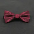 Detailed close-up of a burgundy paisley bow tie, classic men's formal suit accessory. - Color 008