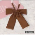 Brown JK uniform bow tie detail shot, solid color square end school neckwear accessory. - Brown
