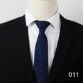 Close-up detail of dark blue business men tie featuring subtle white dot pattern fabric design. - Color 011