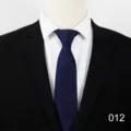 Close-up detail of dark blue men business formal tie with subtle abstract texture pattern. - 012