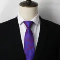 Detailed view of a stylish blue and red rose pattern men necktie, elegant business accessory. - B006