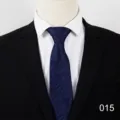 Detail view of dark blue striped men business tie worn with white shirt and black suit. - Color 015
