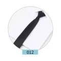 Detail view of a classic black business necktie for men, shown on a crisp white shirt. - 012