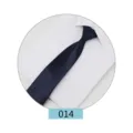 Close-up detail of a dark blue formal men's necktie displayed on a crisp white dress shirt. - Color 014
