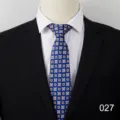 Close-up view of the blue geometric pattern men's business necktie displayed on white shirt. - 027