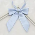 Close-up detail of light blue ribbed JK uniform bow tie, textured fabric and pointed end. - 005-Light Blue