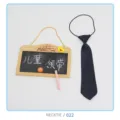 Detail view of children elastic necktie with blackboard prop for kids apparel presentation. - NECKTIE/022