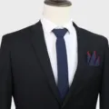Classic men solid dark blue tie with black suit and red trimmed pocket square for formal business. - Dark Blue