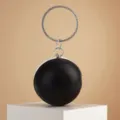Elegant black round sphere evening clutch bag with sparkling rhinestone ring handle detail. - Black