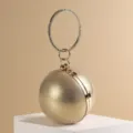Elegant gold sphere evening bag with rhinestone ring handle for luxury party wear. - Gold