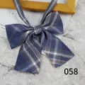 Close-up detail shot of a Japanese style blue plaid JK collar bow tie with ribbon straps. - Color 058