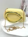 Detailed view of elegant yellow evening clutch bag featuring sculptural gold metallic handle - Premium PU Style / Light Yellow