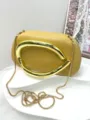 Detailed view of fashionable retro women clutch bag with metallic curved handle and gold chain. - Premium PU Style / Yellow
