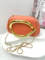 Elegant orange clutch bag with bold gold metallic handle and chain strap for evening events. - Premium PU Style / Orange Pink