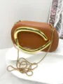 Elegant brown leather evening clutch bag with bold gold curved handle and chain strap. - Premium PU Style / Brown