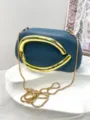 Detail shot of womens blue clutch bag with large gold metal handle and chain strap. - Premium PU Style / Dark Gray
