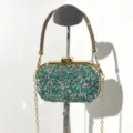 Detailed view of a sparkling rhinestone evening clutch bag with gold chain strap and rhinestones. - A090 Green