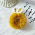 Cute yellow plush hair scrunchie with bunny ears, soft and fluffy detail view for daily hair styling. - Turmeric