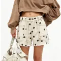Women's chic polka dot denim shorts with eyelets and drawstring for stylish summer casual wear. - S / White